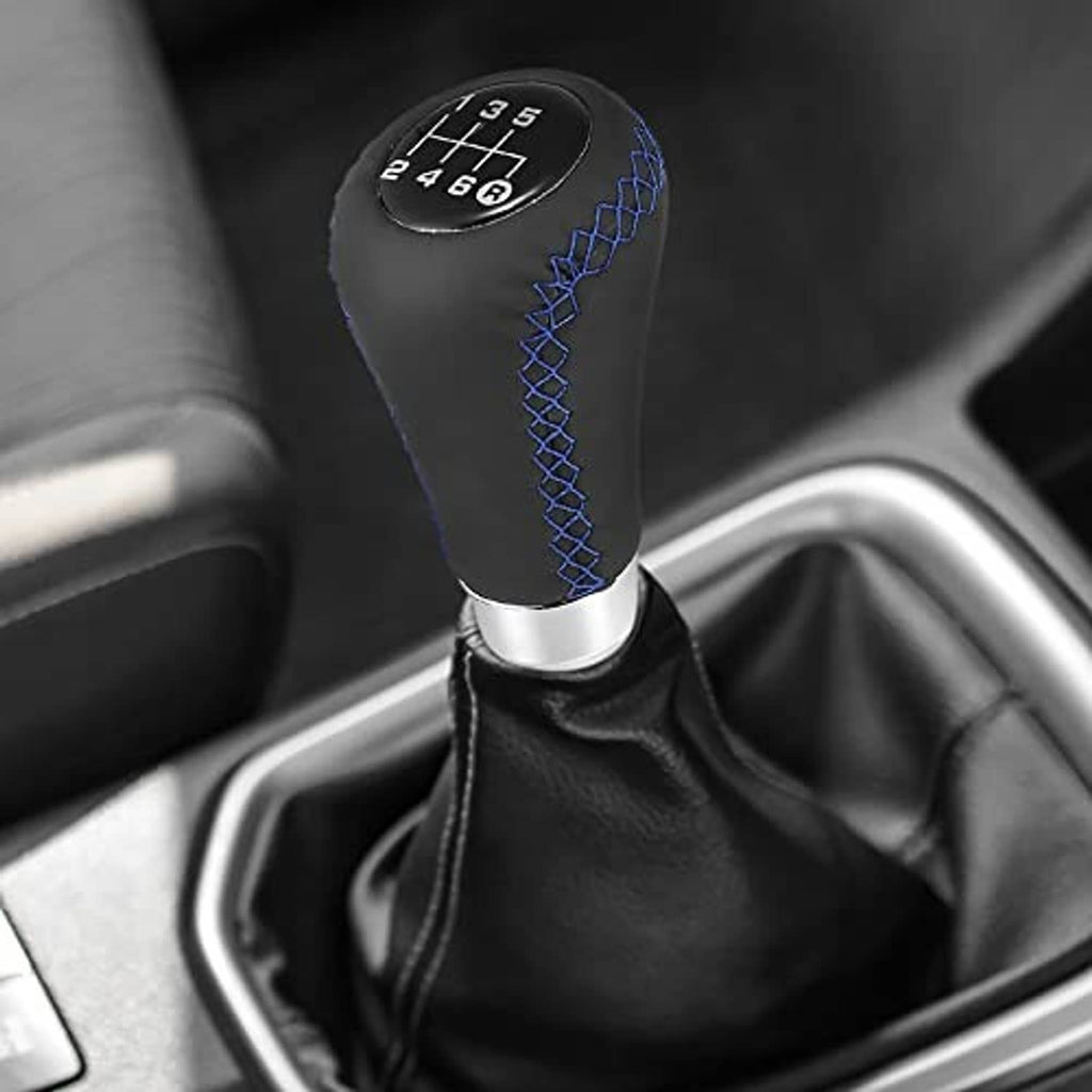Black gear shift knob with blue stitched grip and silver base installed in car interior
