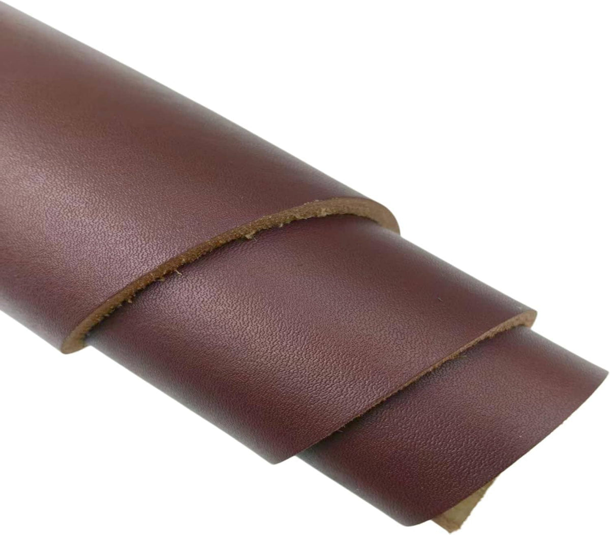 Vegetable-tanned leather sheet, medium brown, close-up of folded edges and grain.