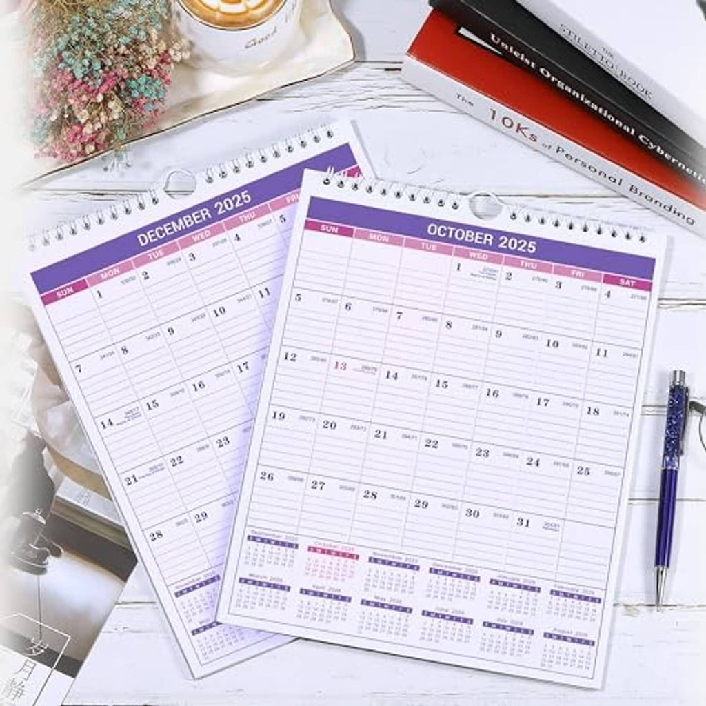 Two Small 2025 wall calendars on desk, October 2025 and December 2025 views