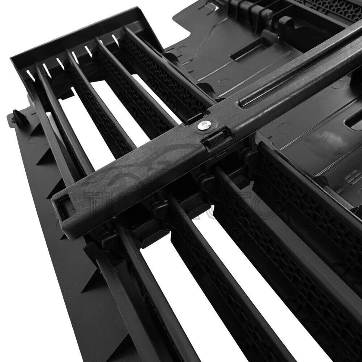 Radiator active grille shutter with motor, close-up of black slats and textured mesh inserts