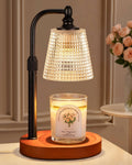 Candle warmer lamp with black metal dome shade and round walnut base, holding a jar candle