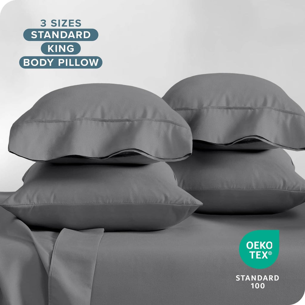 Grey standard pillowcases, two matching cases with envelope closure and soft sheen.