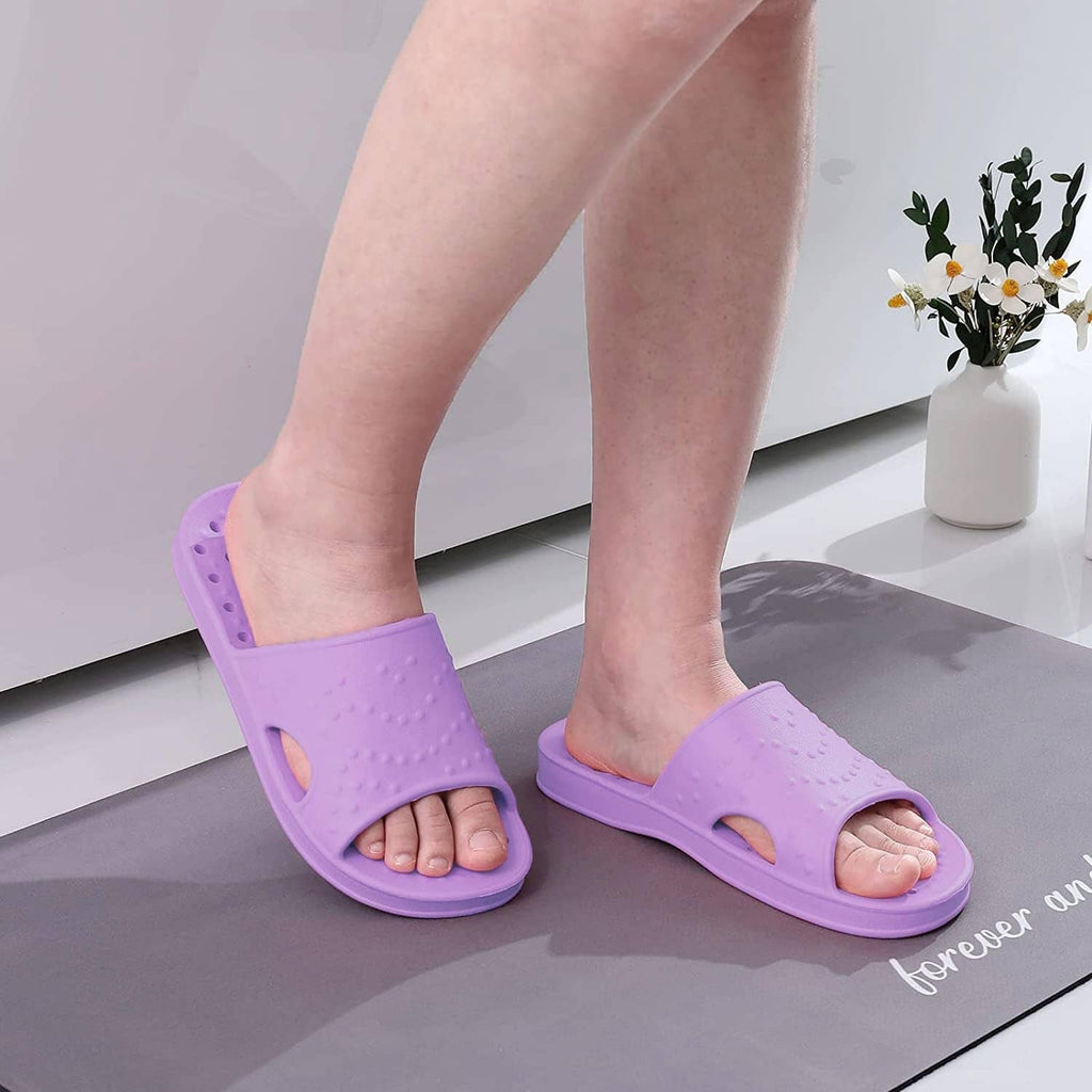 Purple slide sandals worn with open toe and cutout vamp.
