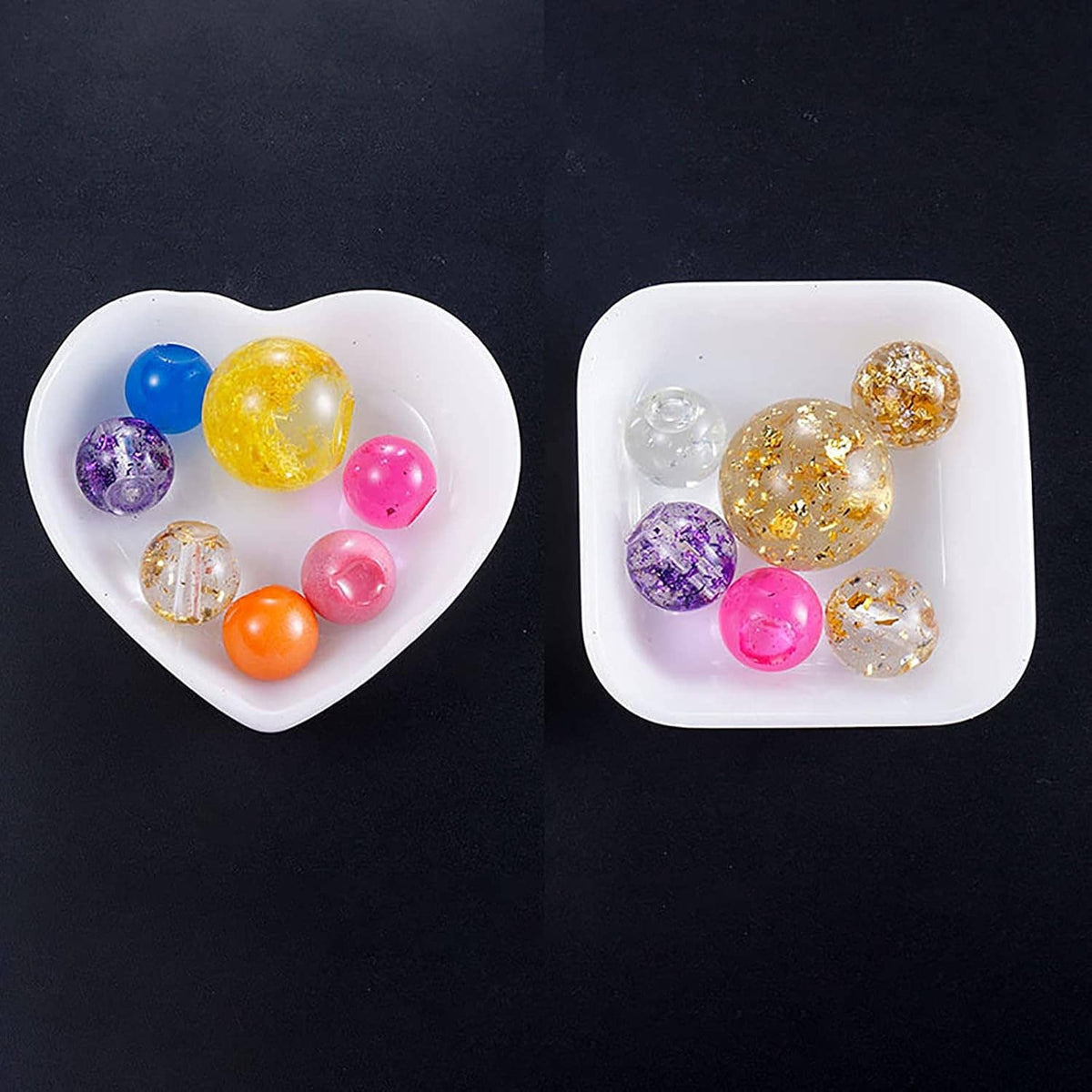 Two heart-shaped resin storage trays filled with colorful glitter beads and charms