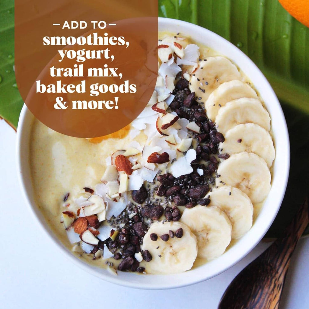 Cacao sweet nibs sprinkled on smoothie bowl with banana and granola pieces