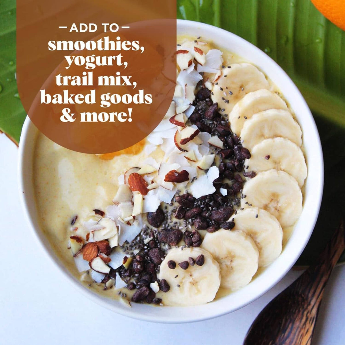 Cacao sweet nibs sprinkled on smoothie bowl with banana and granola pieces