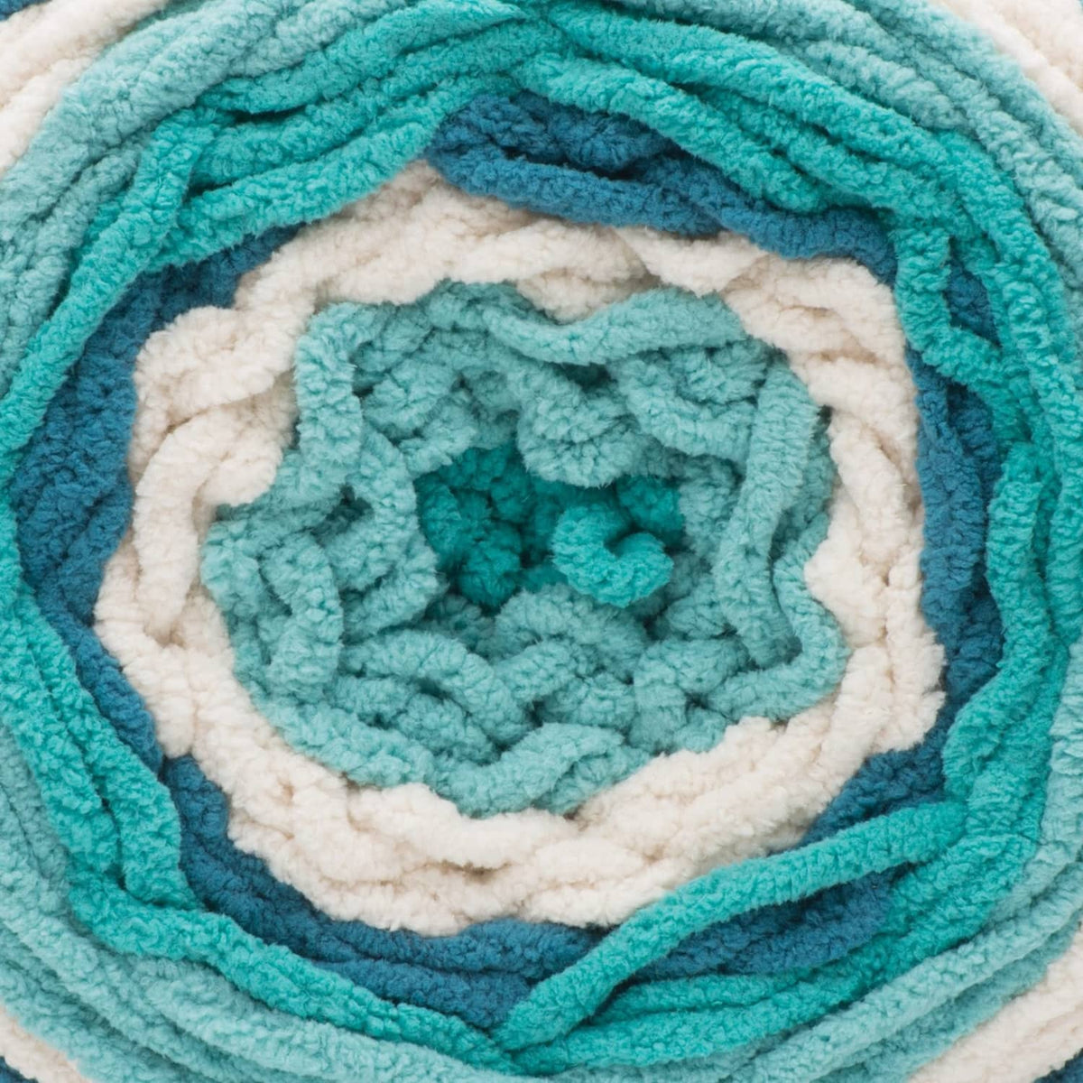 Close-up of teal and cream striped yarn blanket texture with rosette center.