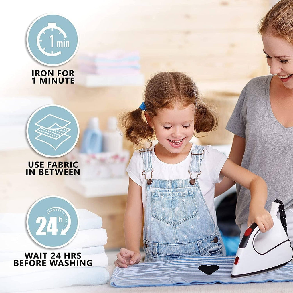 Child ironing an iron-on patch onto clothing on a stack of fabric