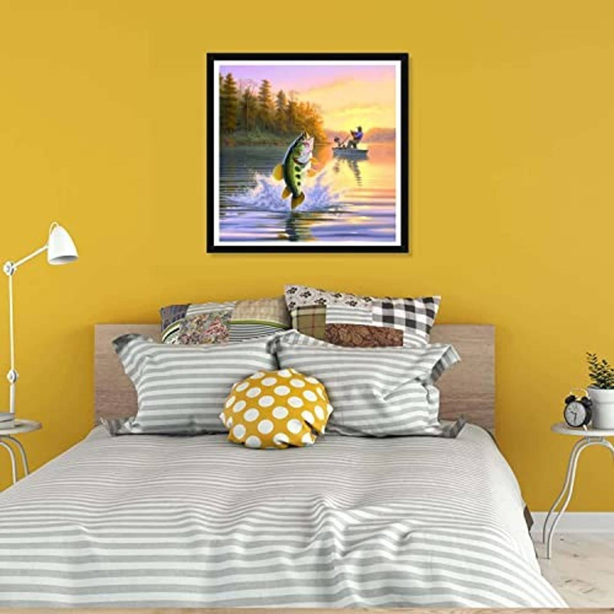 Diamond art canvas with jumping fish and fisherman, in a black frame