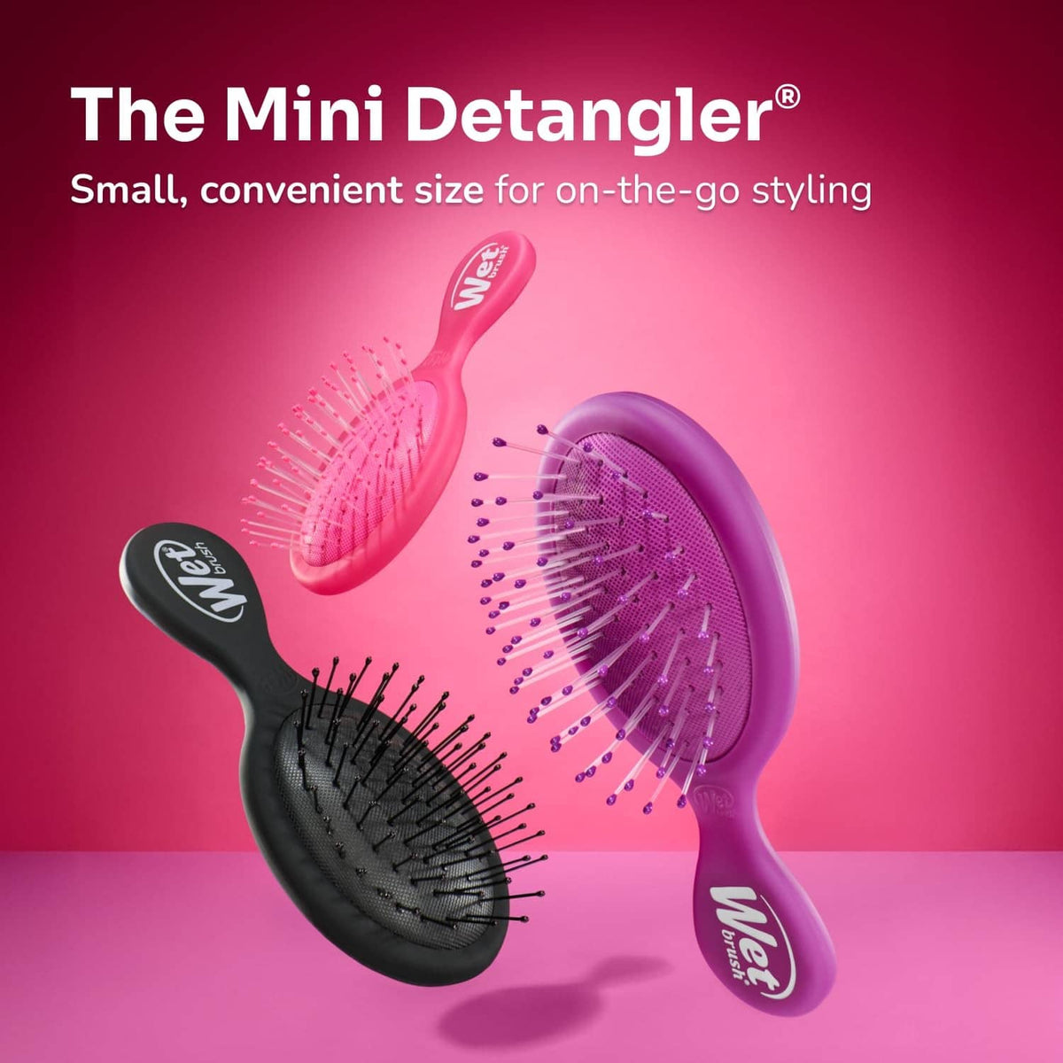 Mini detangling hair brush with black and purple paddle pads and bristle tips