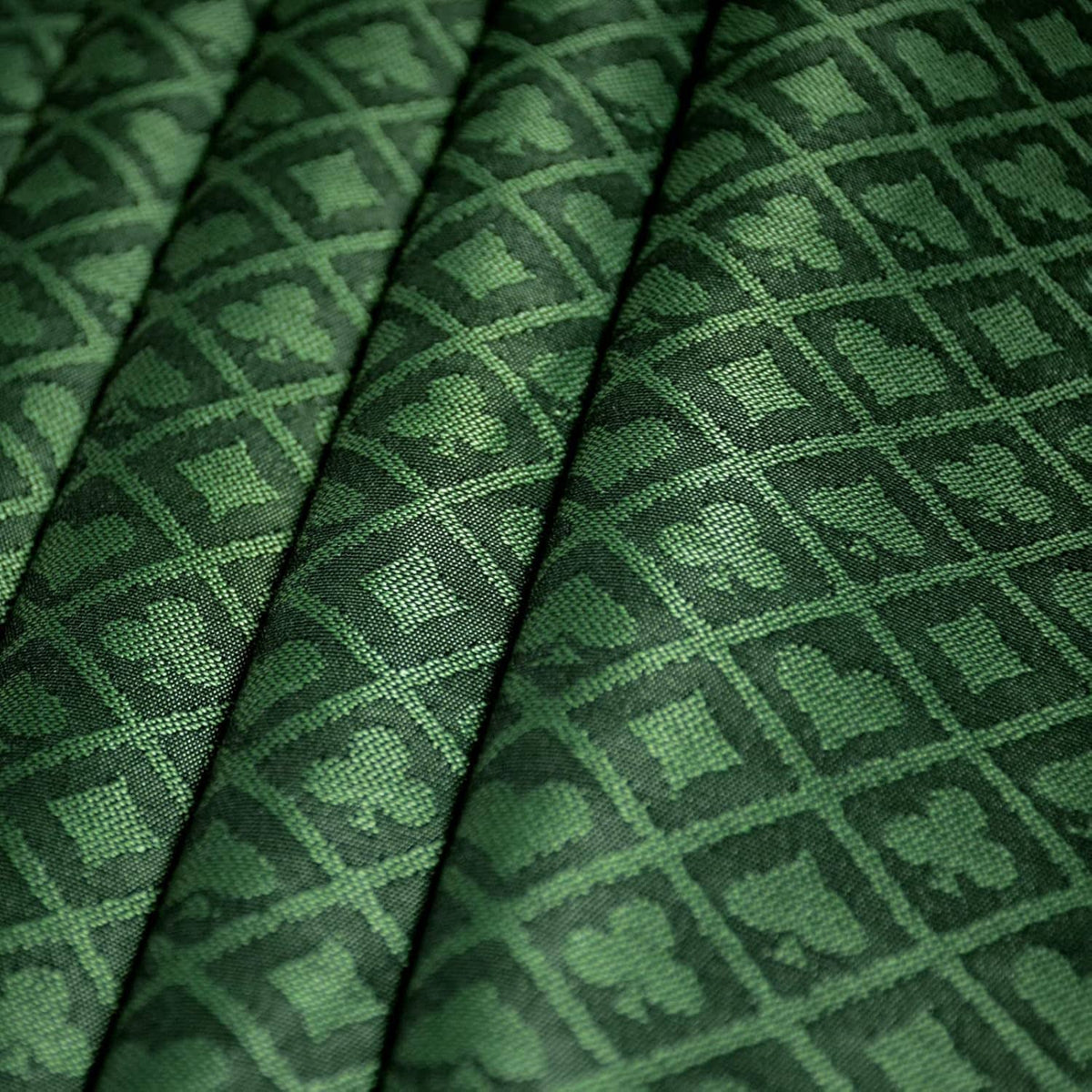 Folded green poker table speed cloth with geometric diamond pattern
