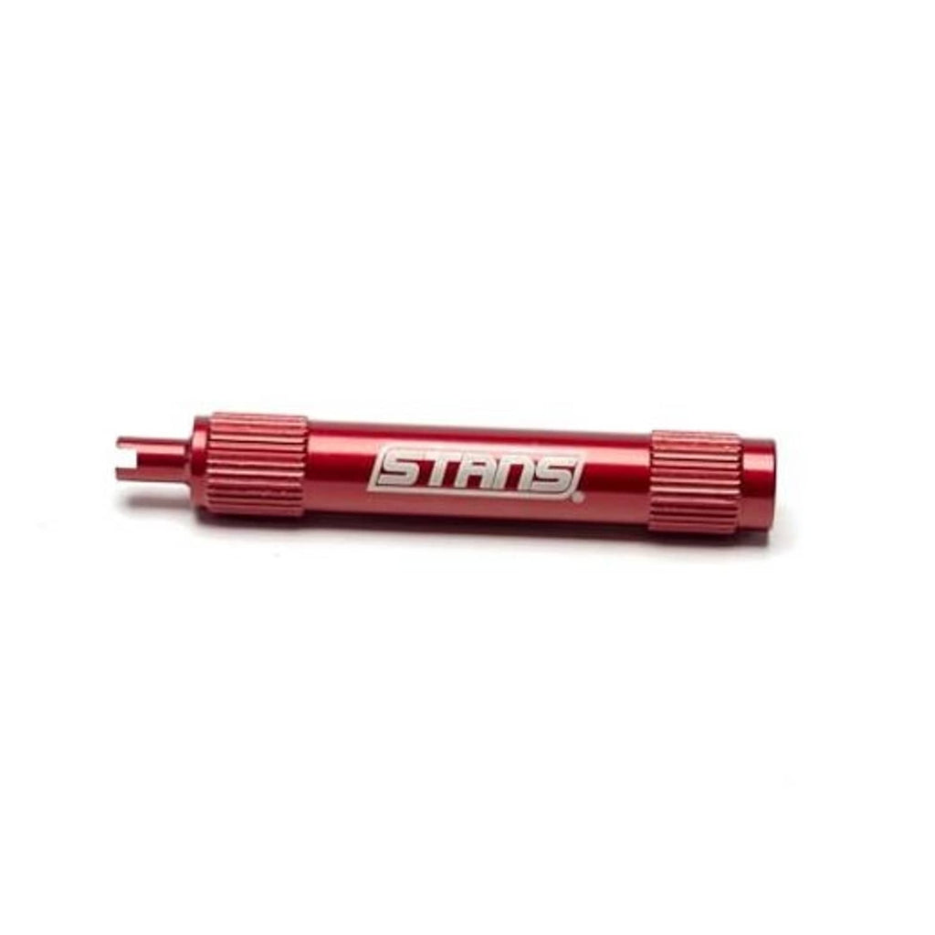 Red STANS tubeless core remover tool with knurled grips and pointed end