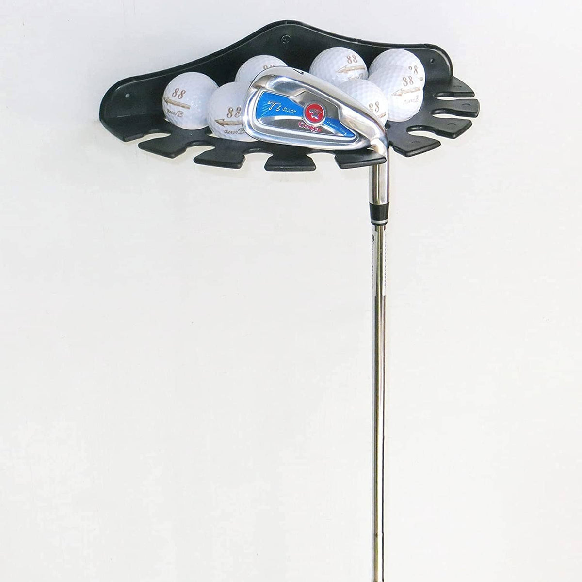 Black golf putter display rack with club heads and several golf balls in holders.