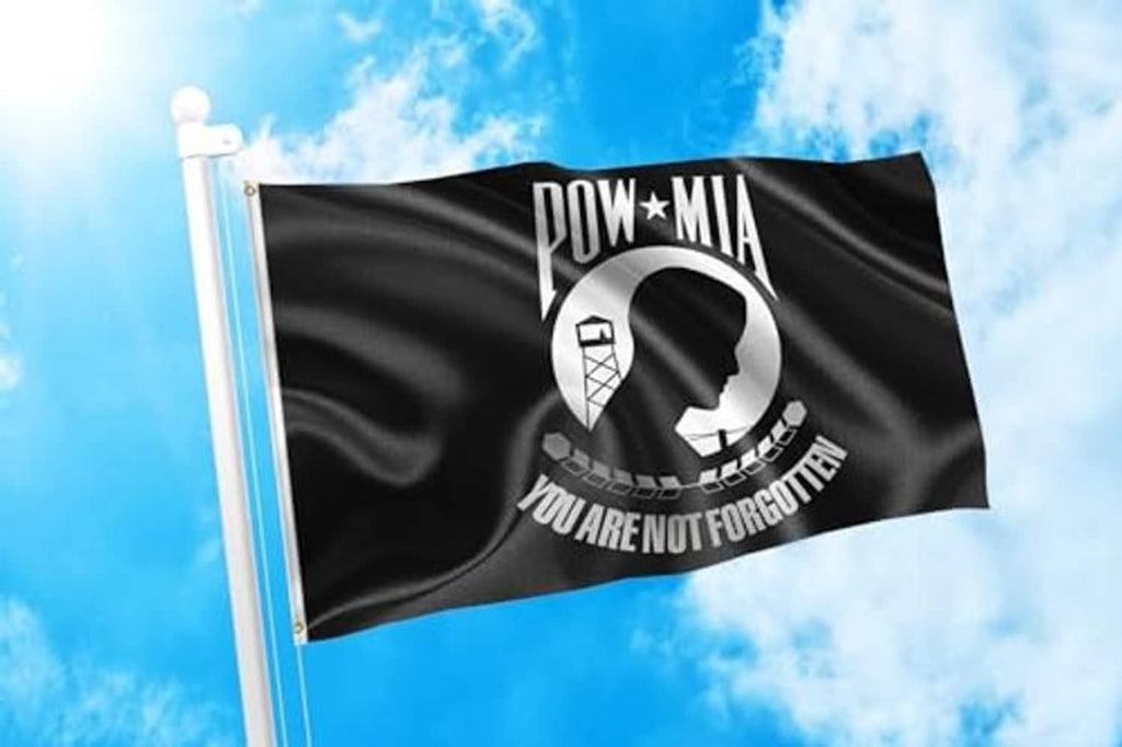 POW-MIA memorial flag on a pole, black fabric with white emblem and “YOU ARE NOT FORGOTTEN”