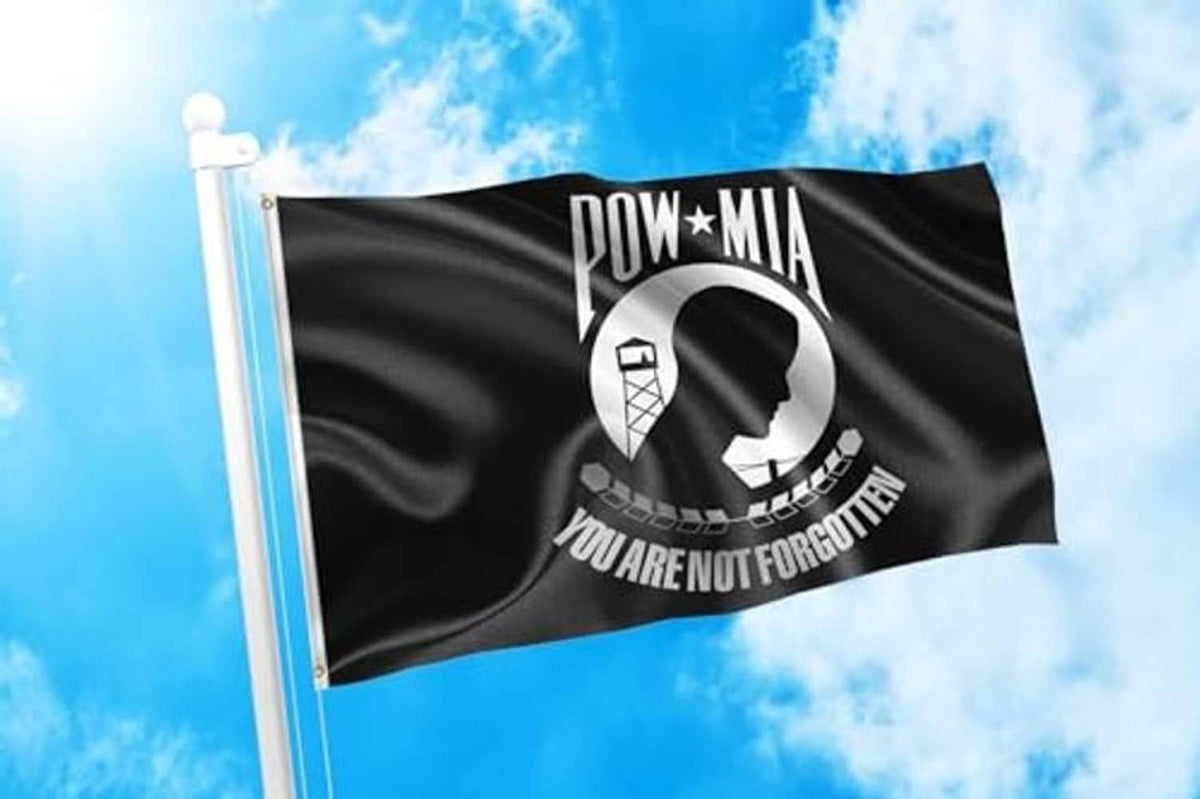 POW-MIA memorial flag on a pole, black fabric with white emblem and “YOU ARE NOT FORGOTTEN”