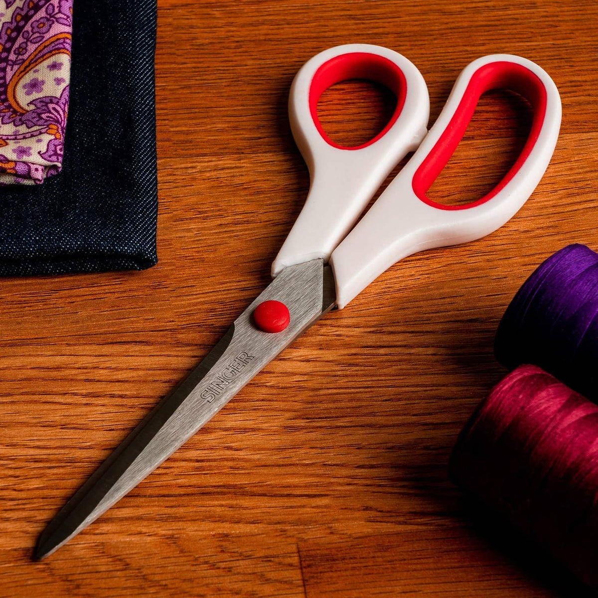 Red-and-white handled Singer fabric scissors with sharp stainless steel blades