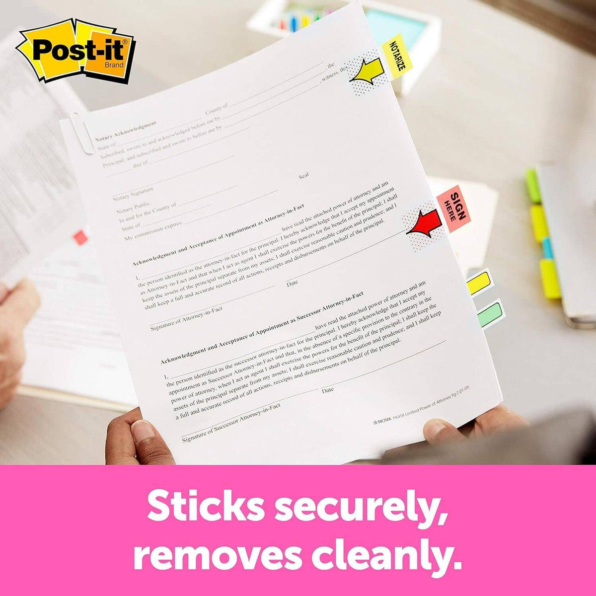 Desktop sticky note dispenser with red notes, used to mark documents with notes