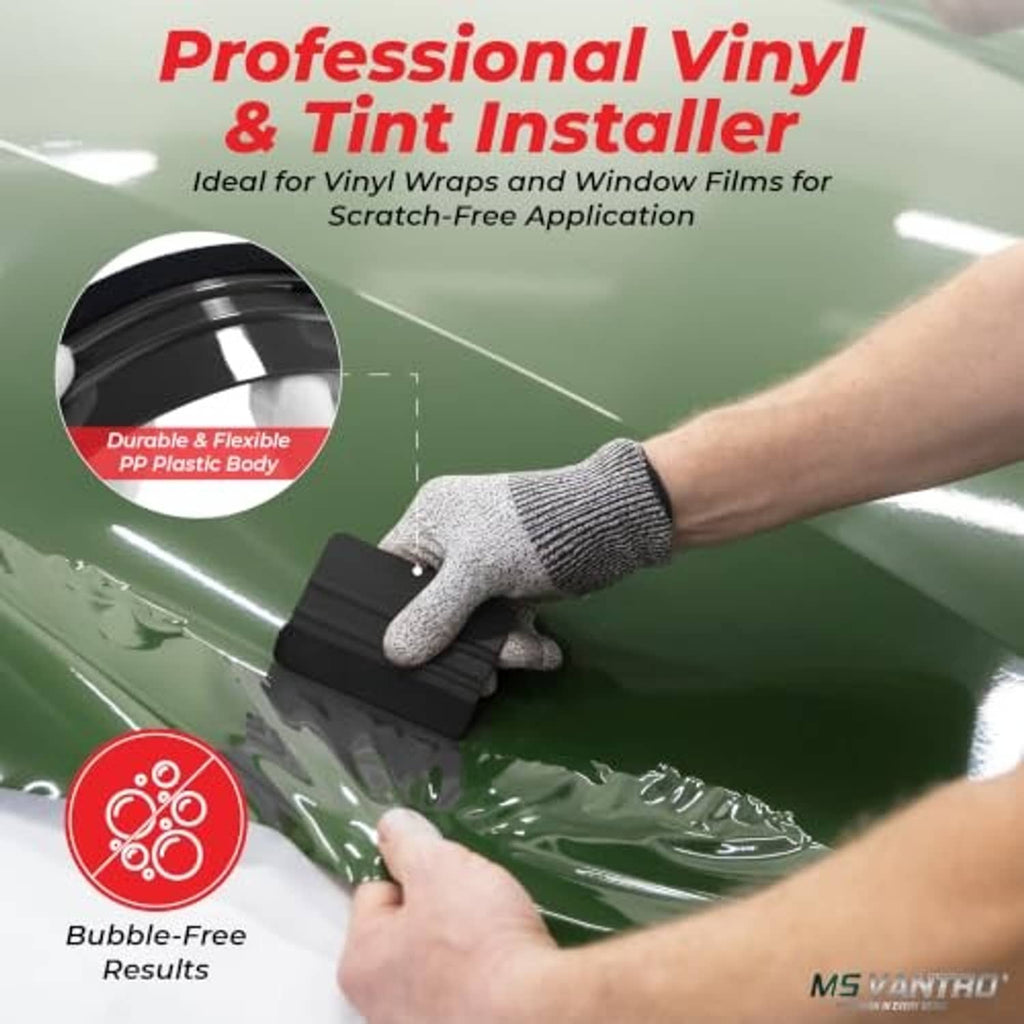 Hand using a black felt-edge squeegee to smooth vinyl wrap on a surface