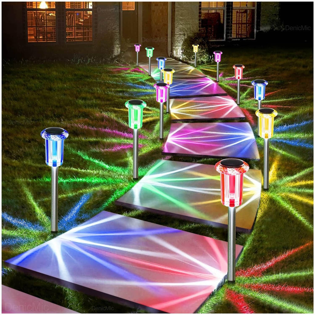 Outdoor solar LED stake lights with multi-color glowing beams along a garden path