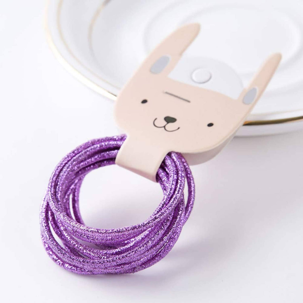 Purple glitter hair elastic loop on bunny-shaped holder
