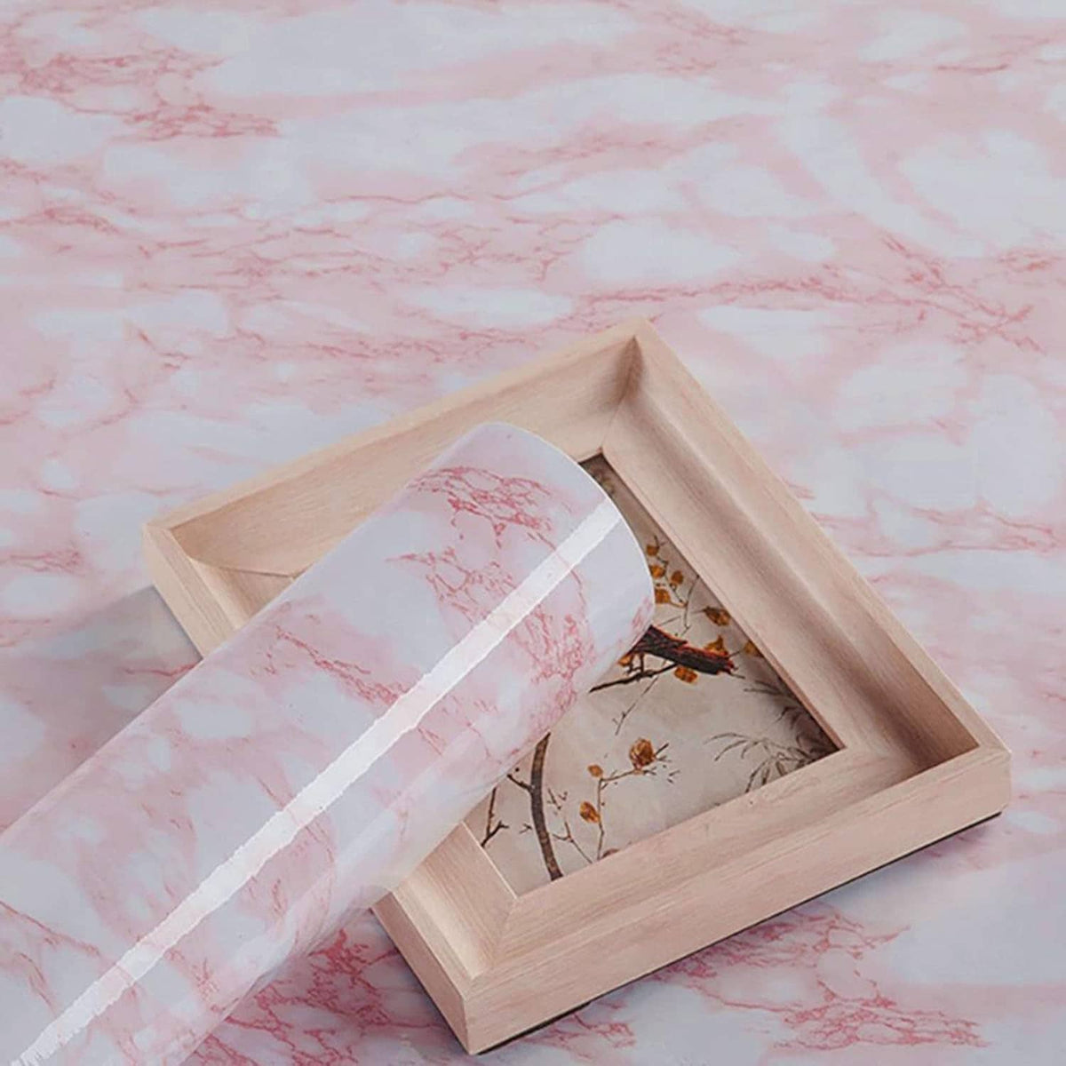 Pink marble peel-and-stick film laid across a wooden tray frame opening
