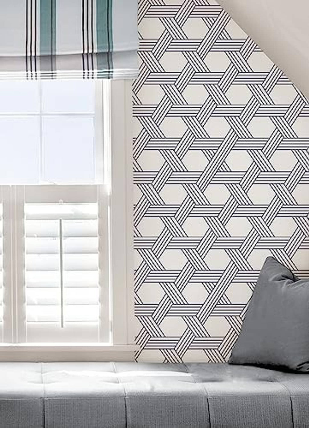Blue-and-white geometric lattice wallpaper on a room corner wall.