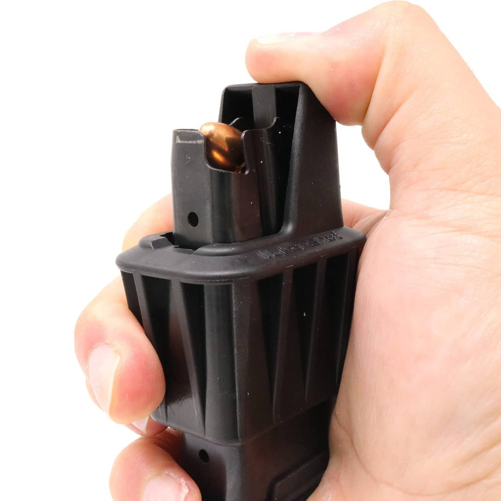Close hand grip on black speed loader with brass rounds visible inside bay