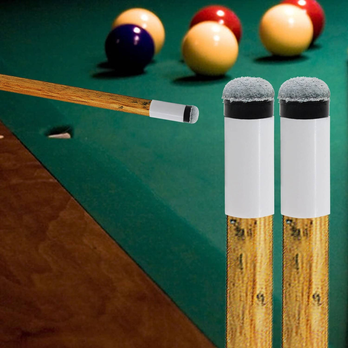Billiard cue replacement tips with soft grey caps on white bodies near cue shaft