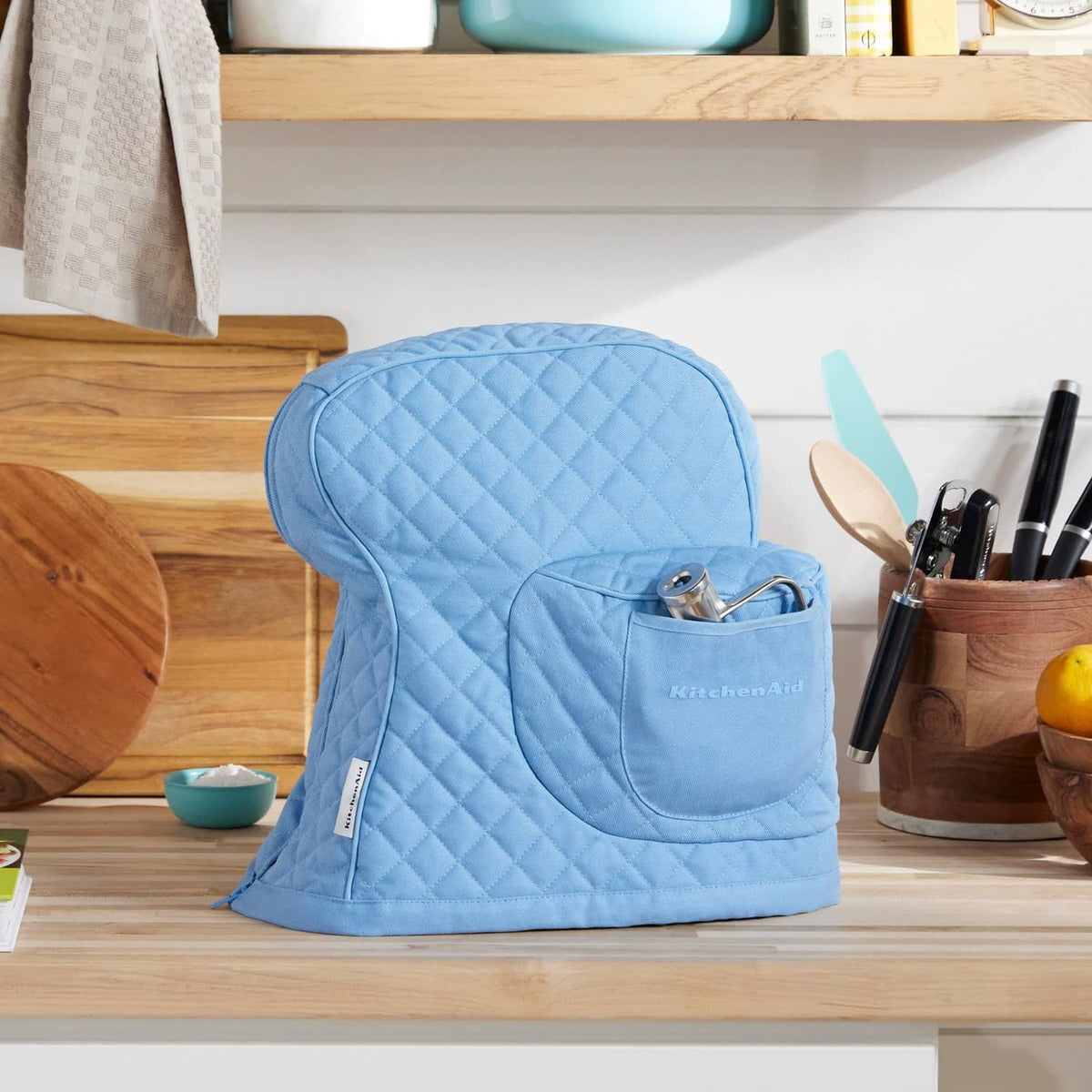 Blue quilted stand mixer cover with front pocket, shaped tilt-head fit