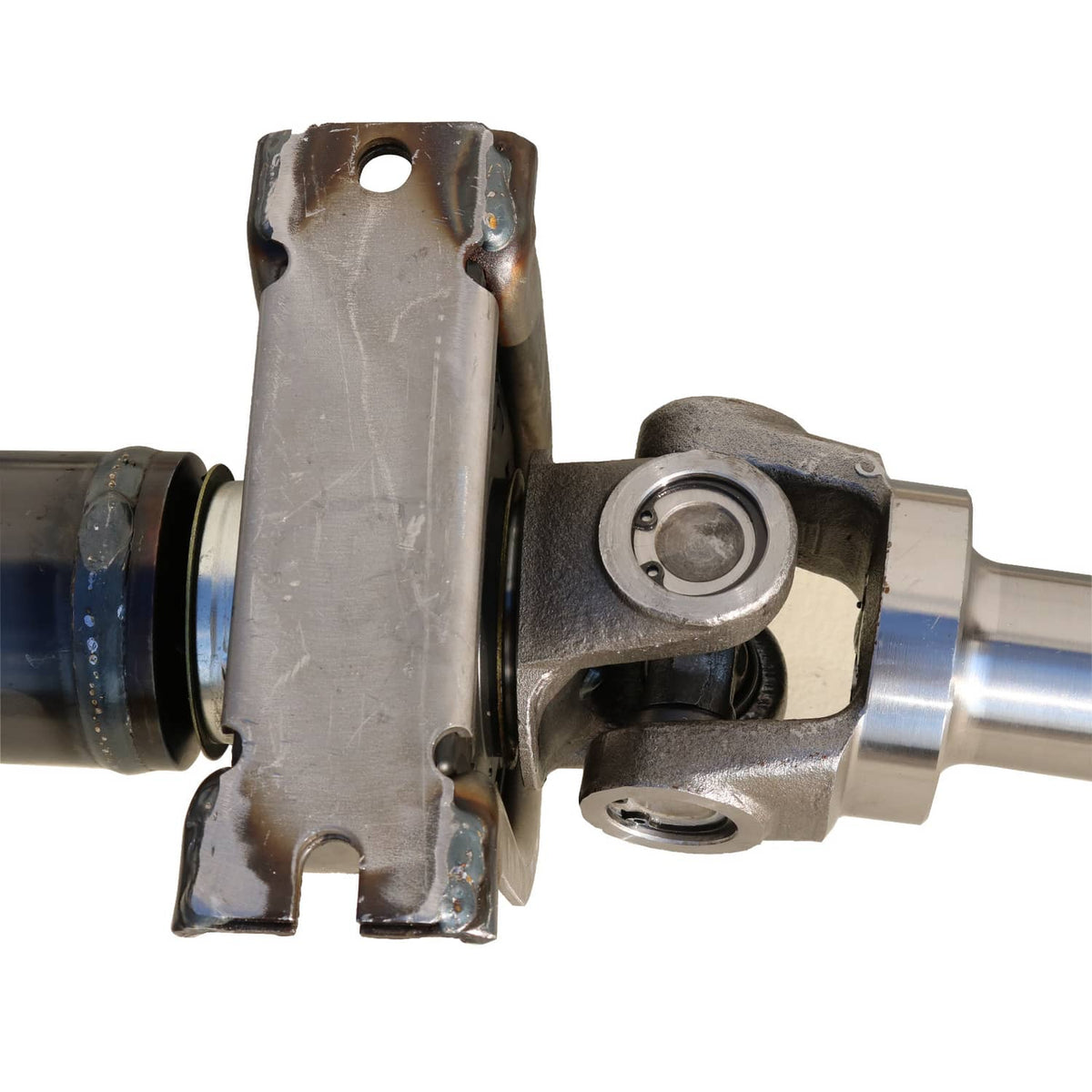 Rear drive shaft assembly close-up of U-joint yoke and mounting plate