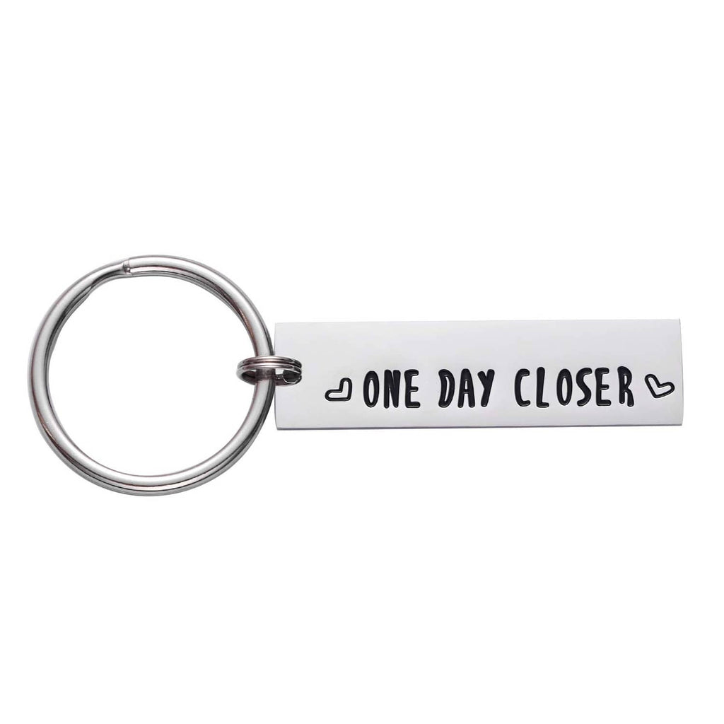 Stainless steel keychain with engraved 'ONE DAY CLOSER' quote and heart accents