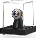 Clear acrylic ring display case with black base and ring holder, featuring a blue-gold ring