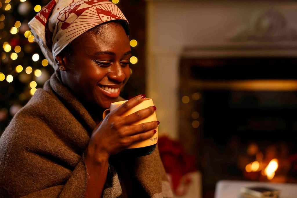 Self-heating coffee mug with lid as someone takes a sip