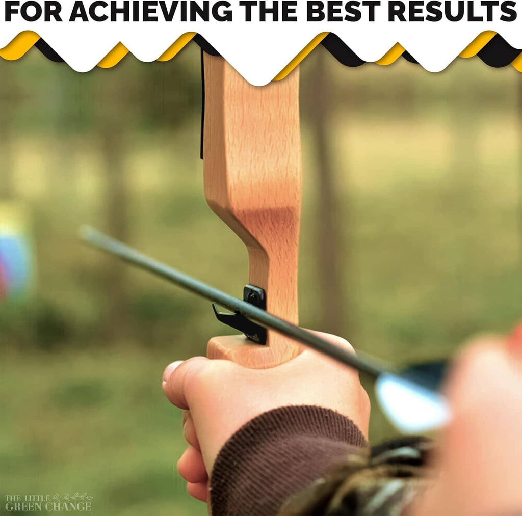 Black recurve arrow rest mounted on a wooden bow, beside the arrow shaft