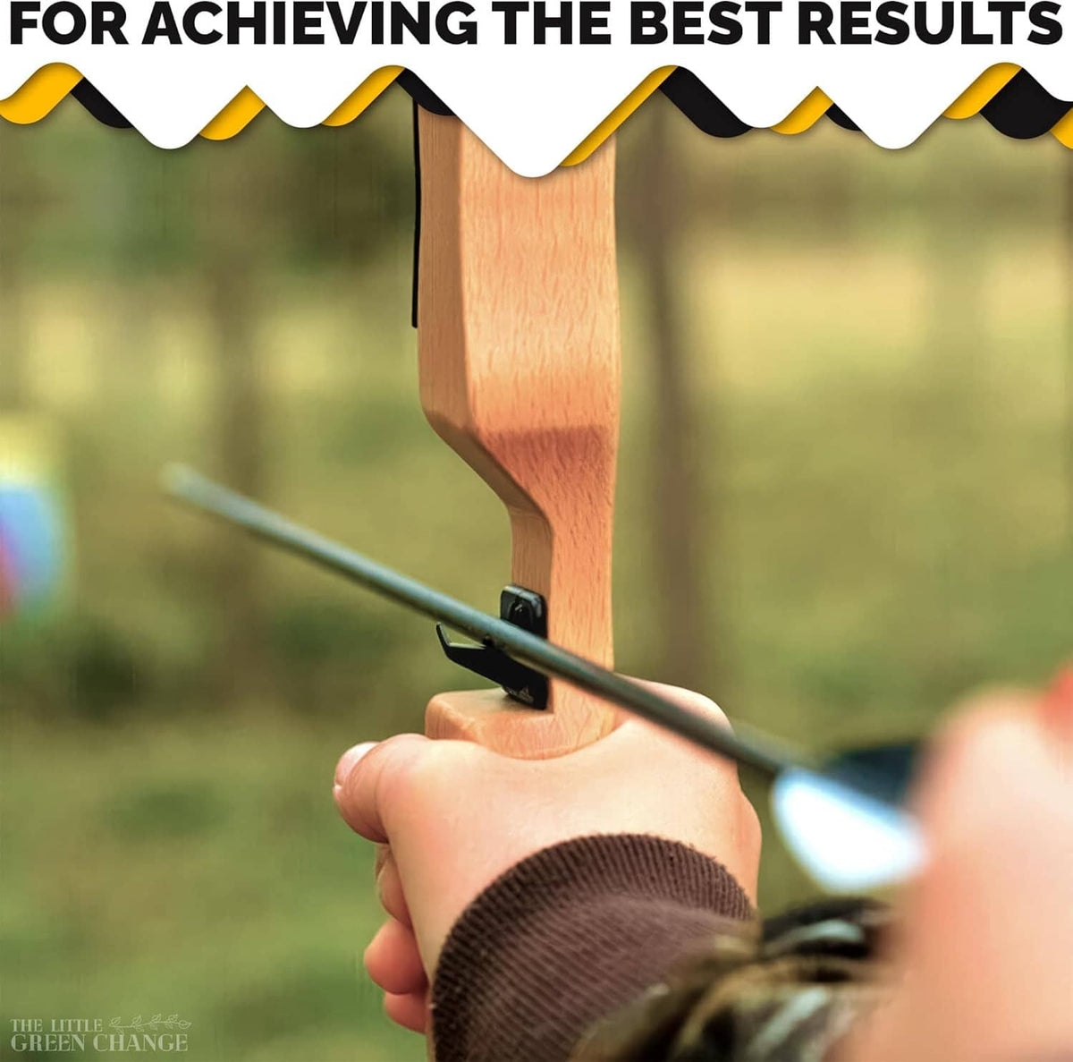Black recurve arrow rest mounted on a wooden bow, beside the arrow shaft