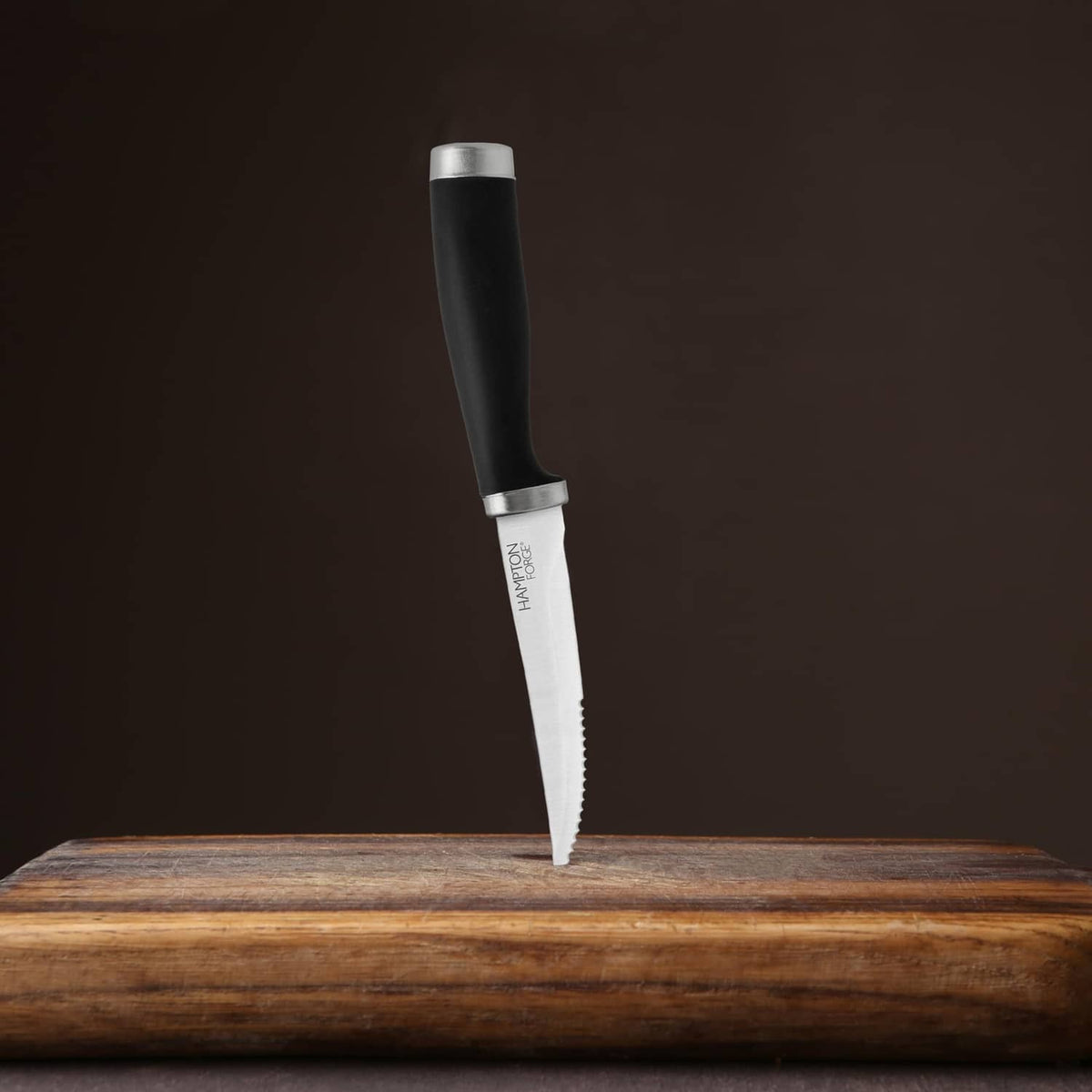 Hampton Forge steak knife with black handle and silver serrated blade