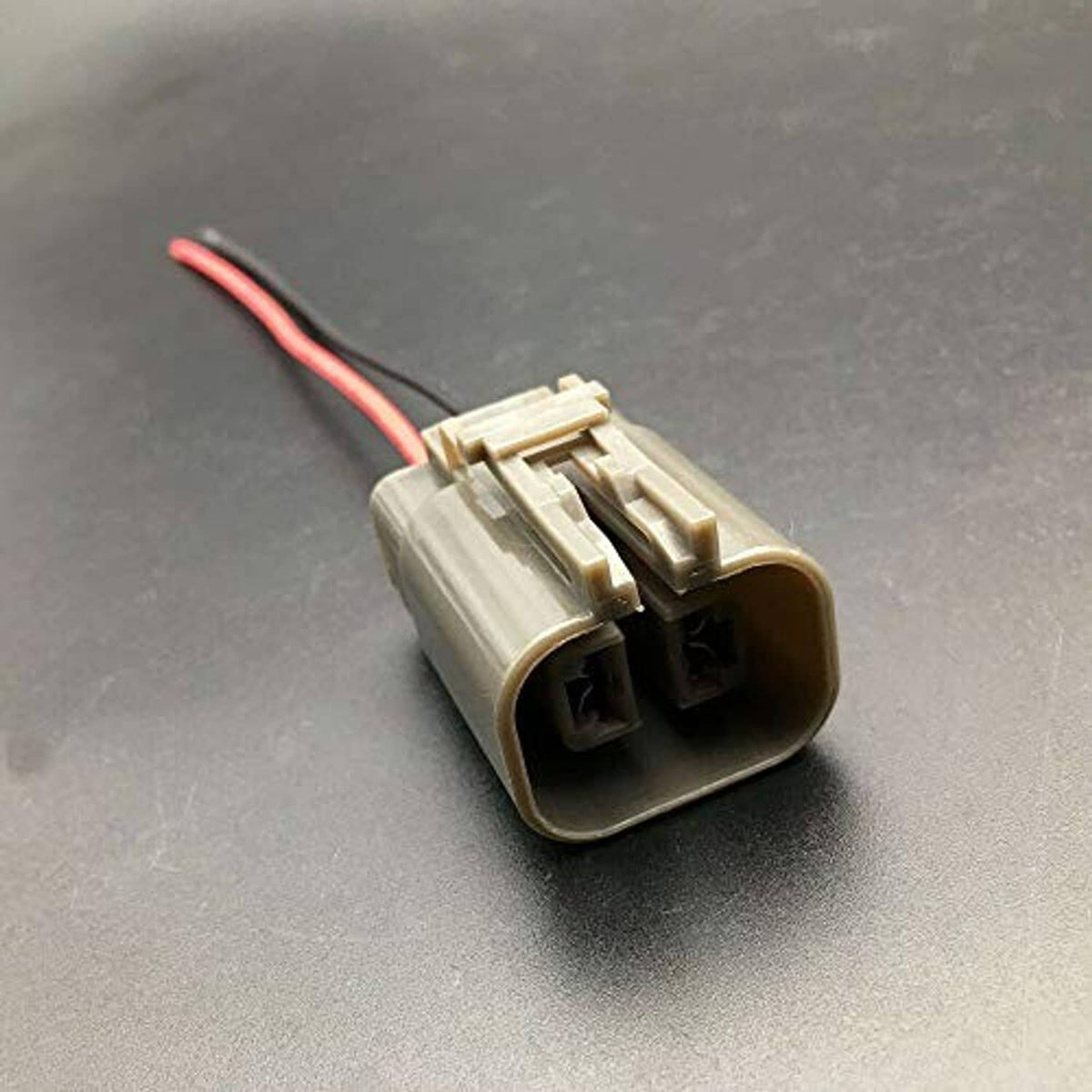 Two-pin connector plug with light gray body and red/black wire pigtail