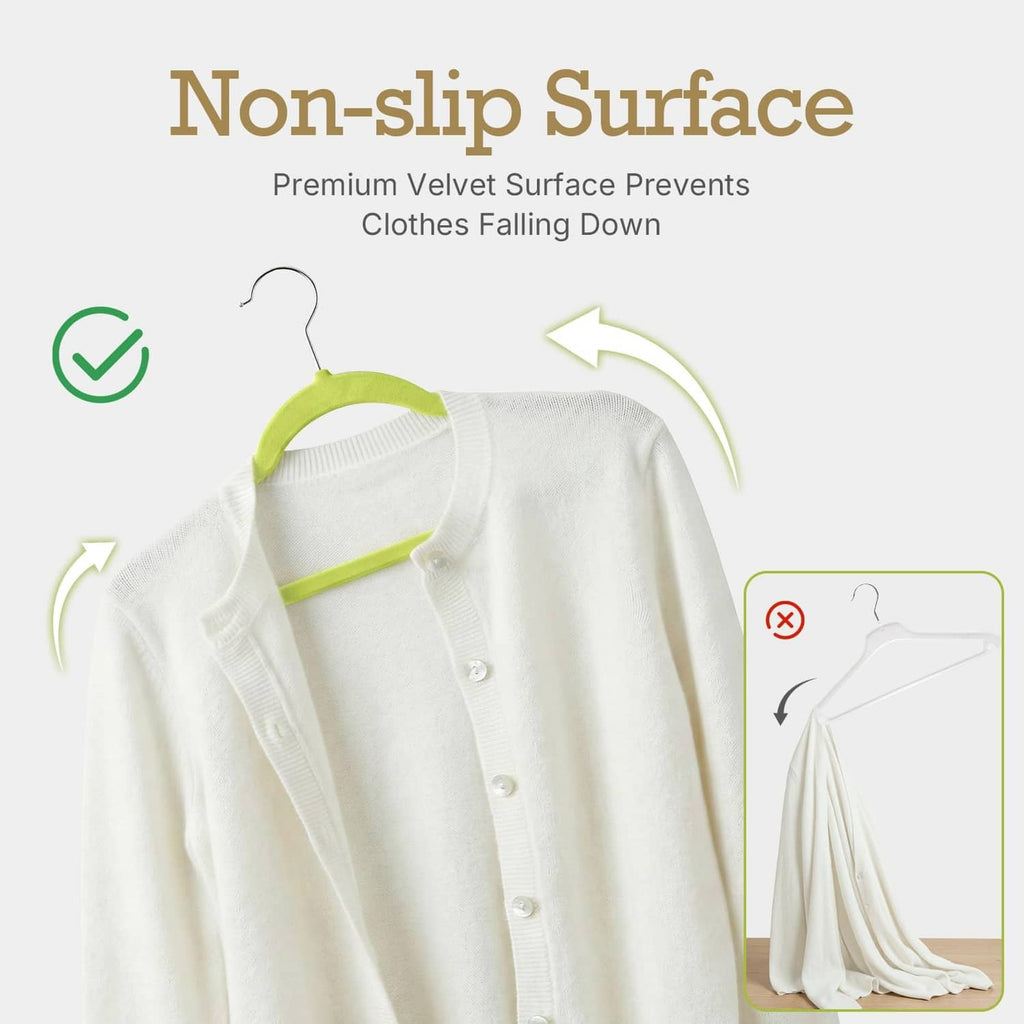 Green non-slip velvet hanger holding a white blouse with rounded shoulder