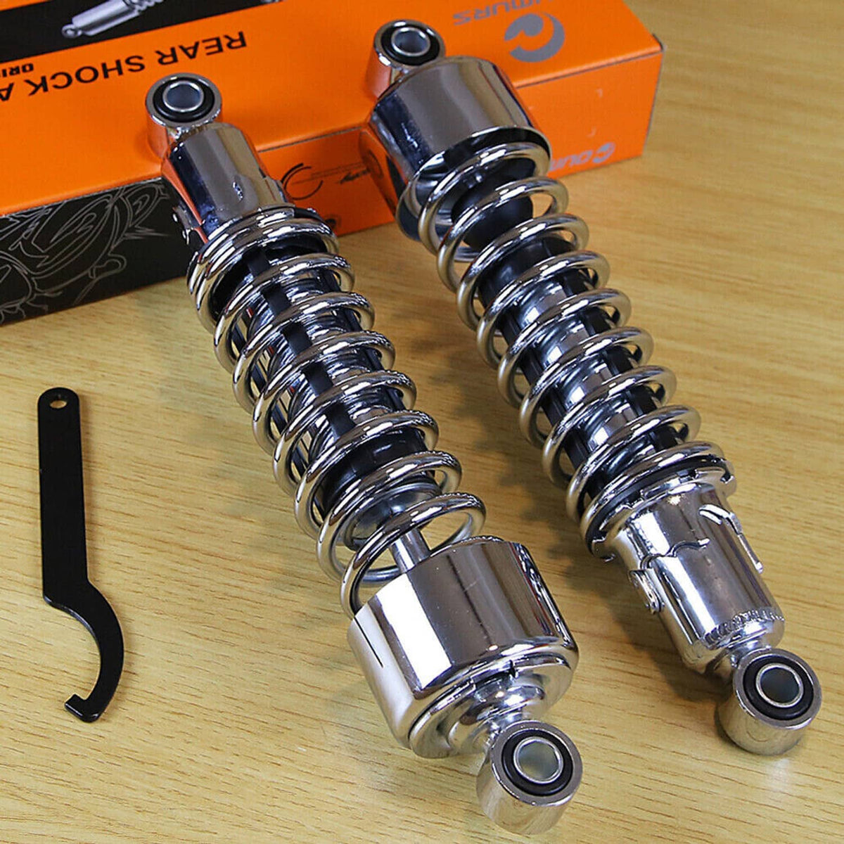 Pair of chrome rear motorcycle shocks with coil springs and installation wrench