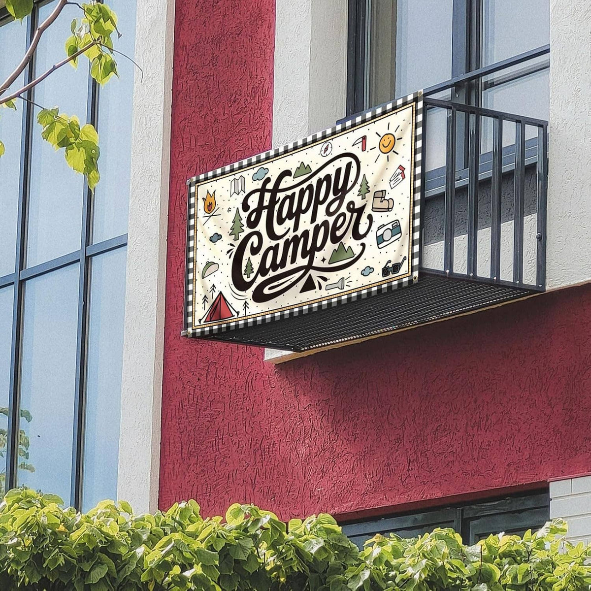 “Happy Camper” camping flag banner with illustrated icons, brass grommets on outdoor railing