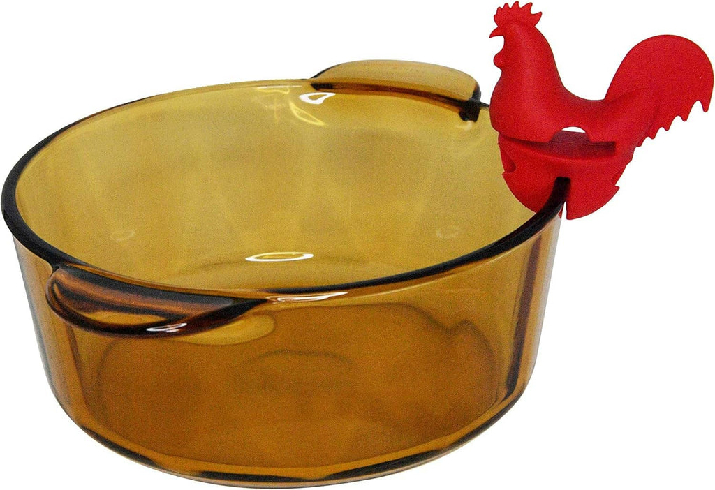 Red rooster spoon holder perched on amber pot rim