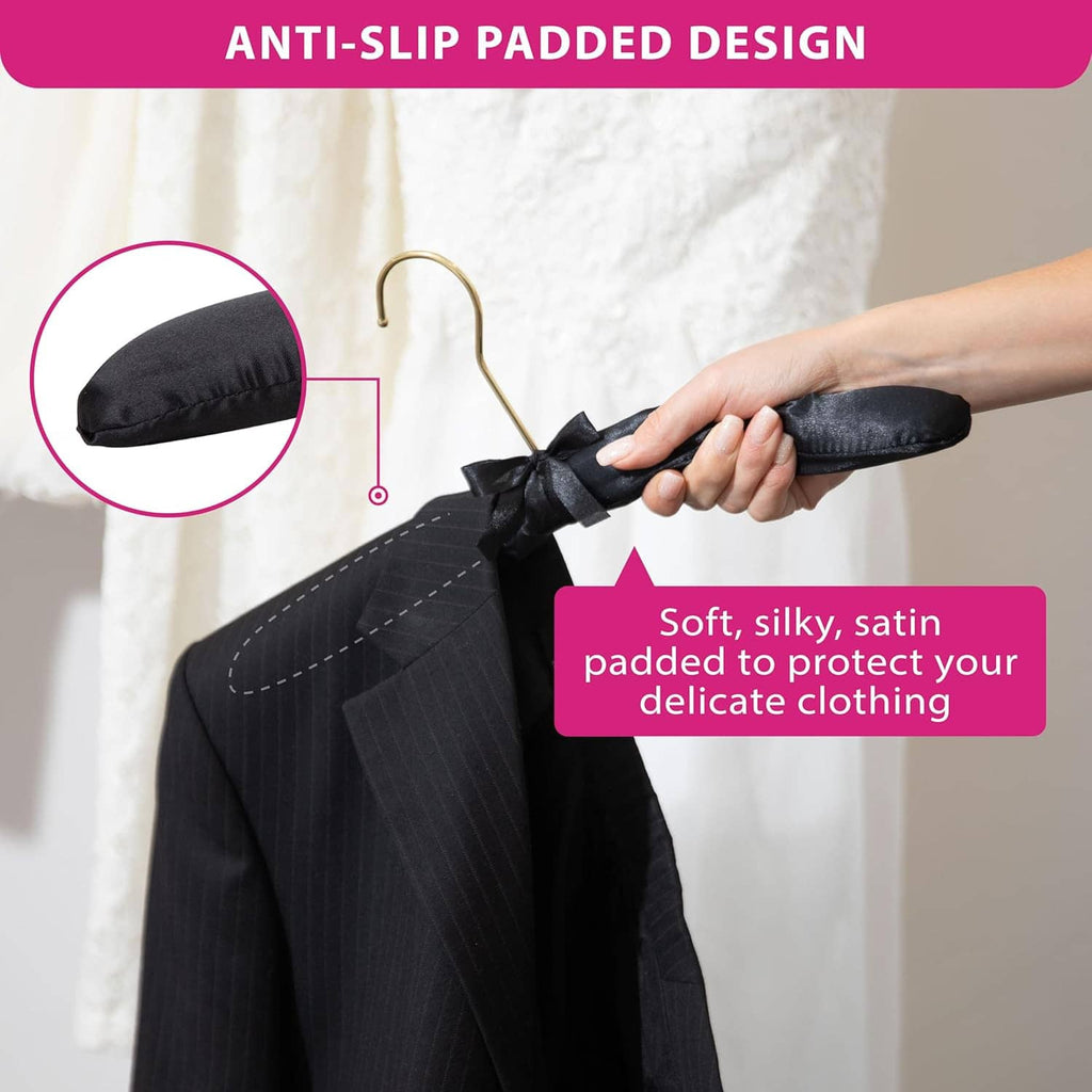 Black fabric padded non-slip hanger with satin bow and gold hook grip detail