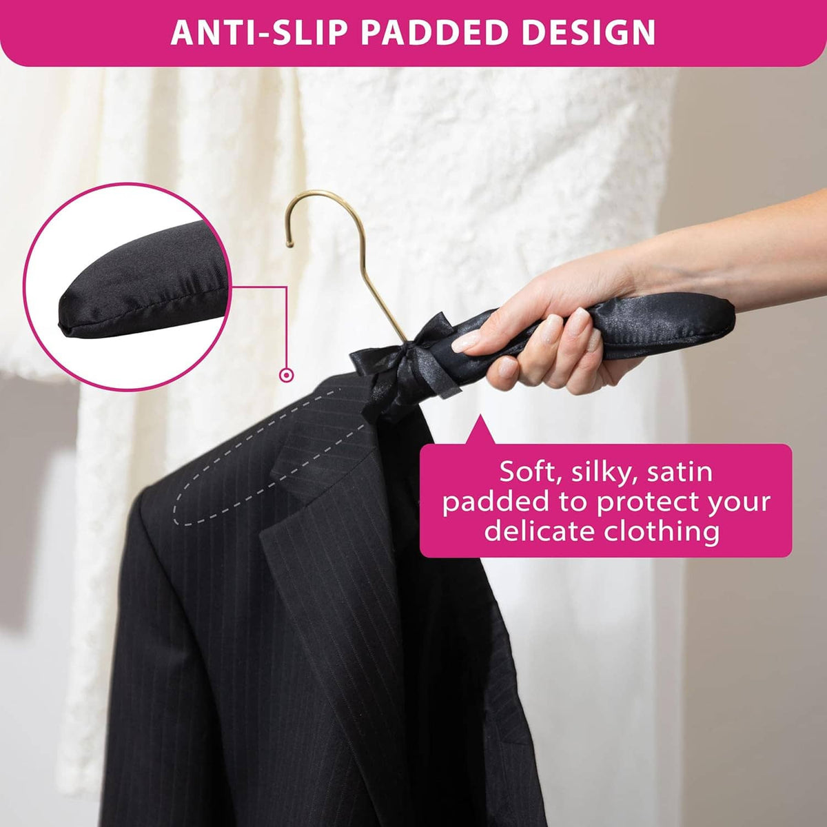 Black fabric padded non-slip hanger with satin bow and gold hook grip detail