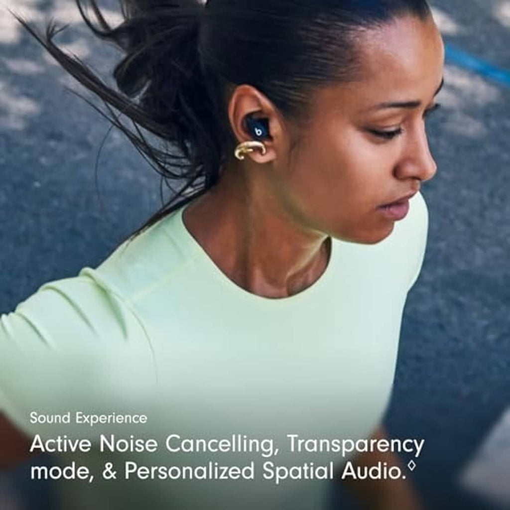 Wireless workout earbuds in dark finish, worn in ear with secure-fit wing tips