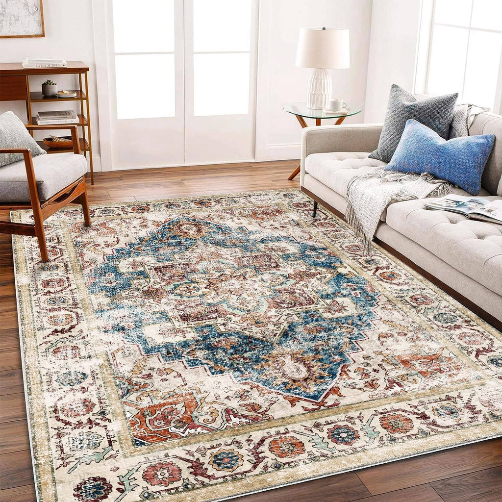 Rectangular boho area rug with distressed medallion pattern, light beige ground and blue details
