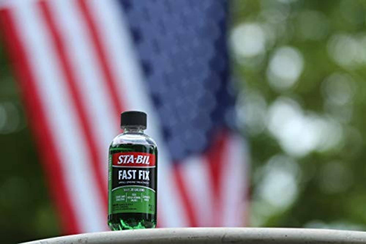 STA-BIL Fast Fix small engine treatment bottle on top of a vehicle hood