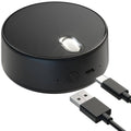 Round black USB computer speaker with built-in microphone, USB cable connected