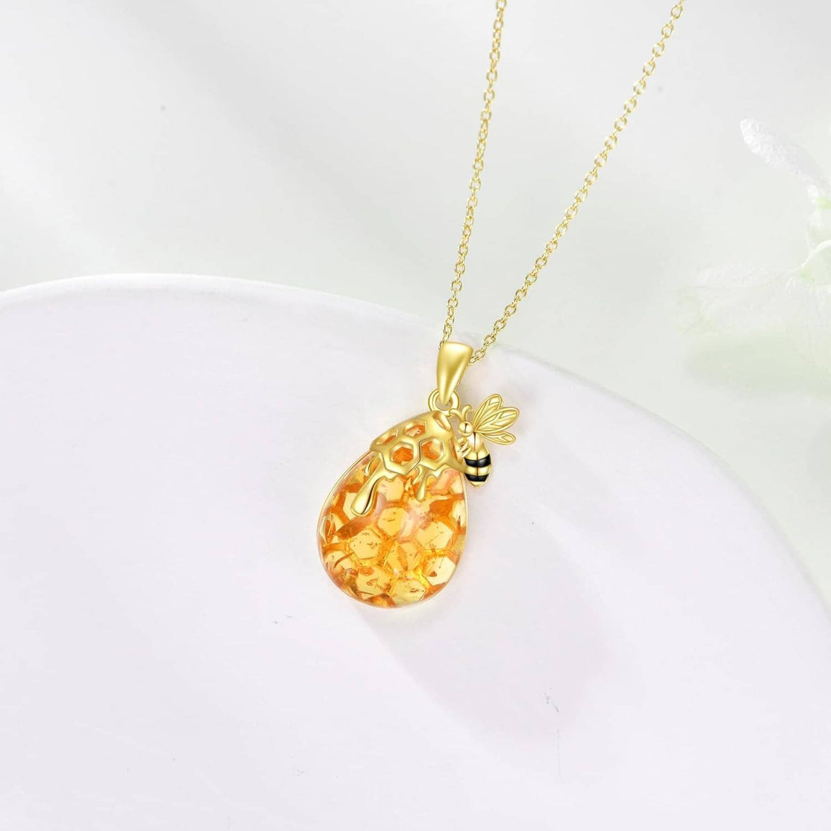 Gold bee amber teardrop pendant necklace on a gold-tone chain