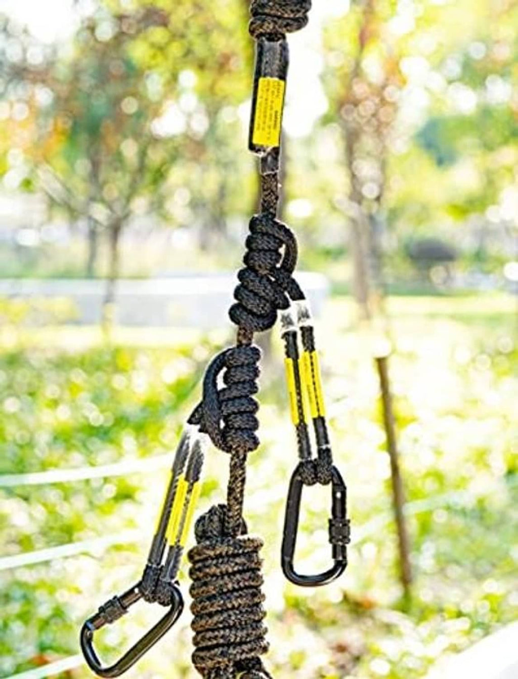 Prusik knots and two carabiners on dark safety rope with yellow-striped sections