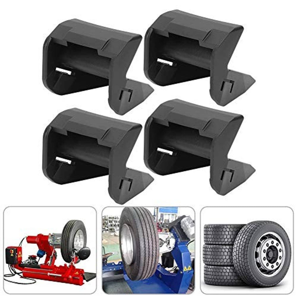 Four dark gray tire changer jaw protectors with beveled contact surfaces